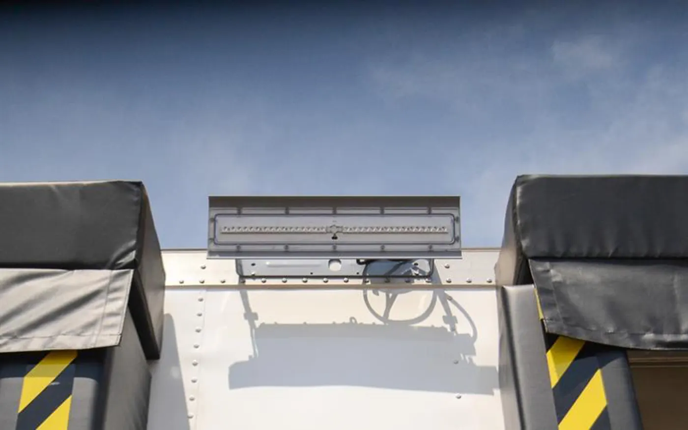 Exterior dock light mounted between dock seals