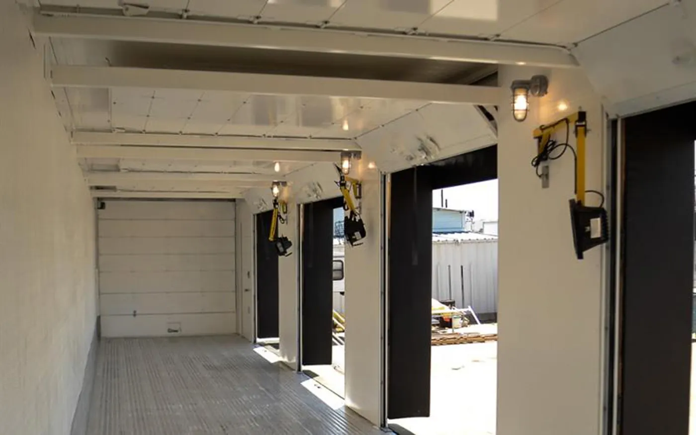 Open multi-door trailer interior with dock lights